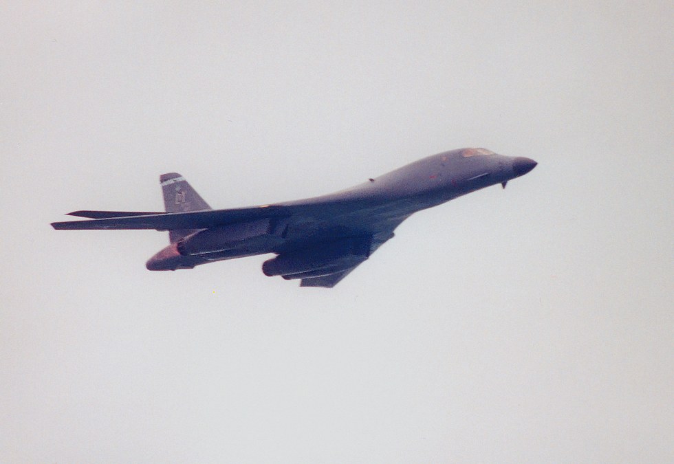 B1 with wings swept back and afterburners lit