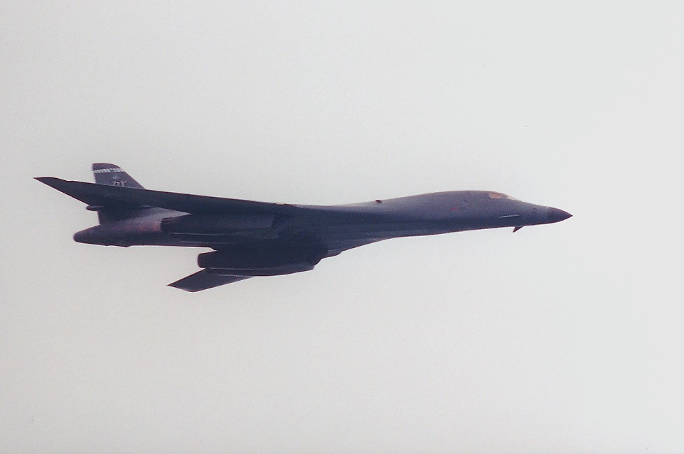 B1 making fast pass with wings swept and afterburner lit