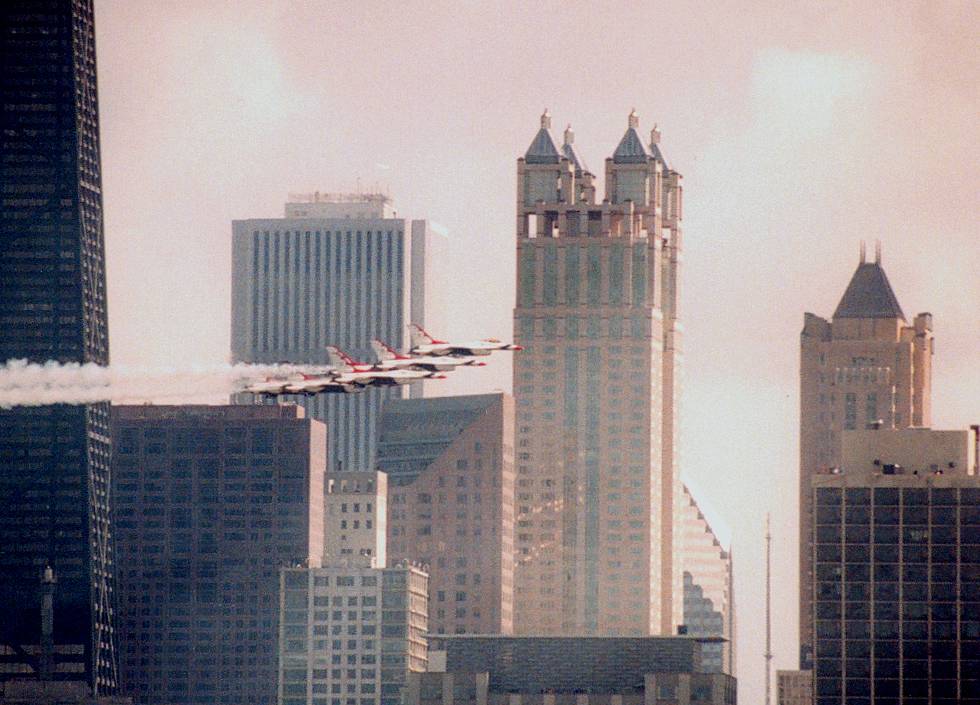 photo #603:  Thunderbirds heading West with buildings behind
