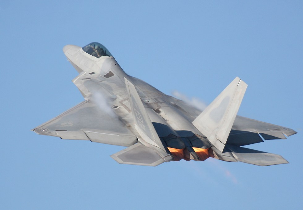 F-22 Raptor fighter climbing with afterburner