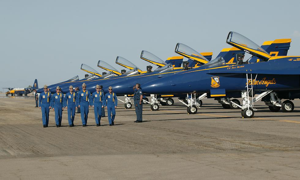 Blues Angels pilots marching beside planes