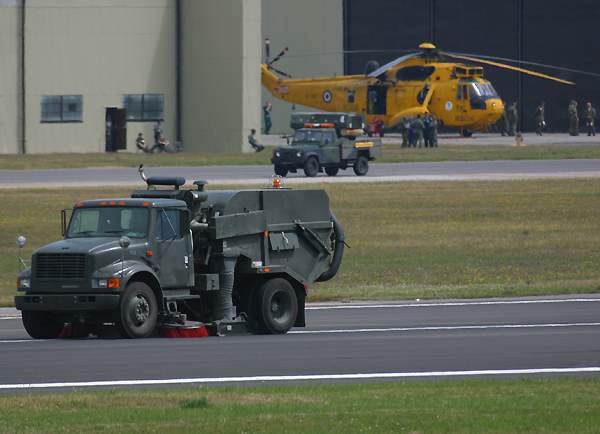 sweeper truck cleaning debris off the runway after the accident