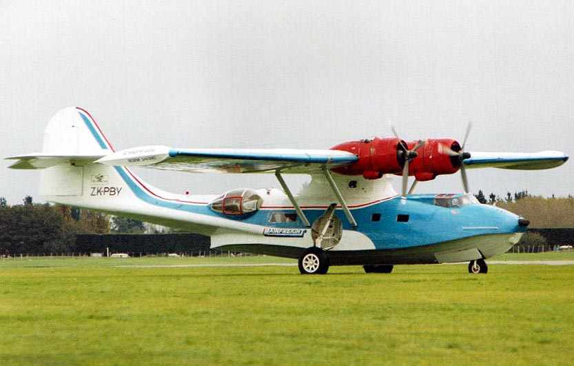 Catalina with raised floats taxying on grass