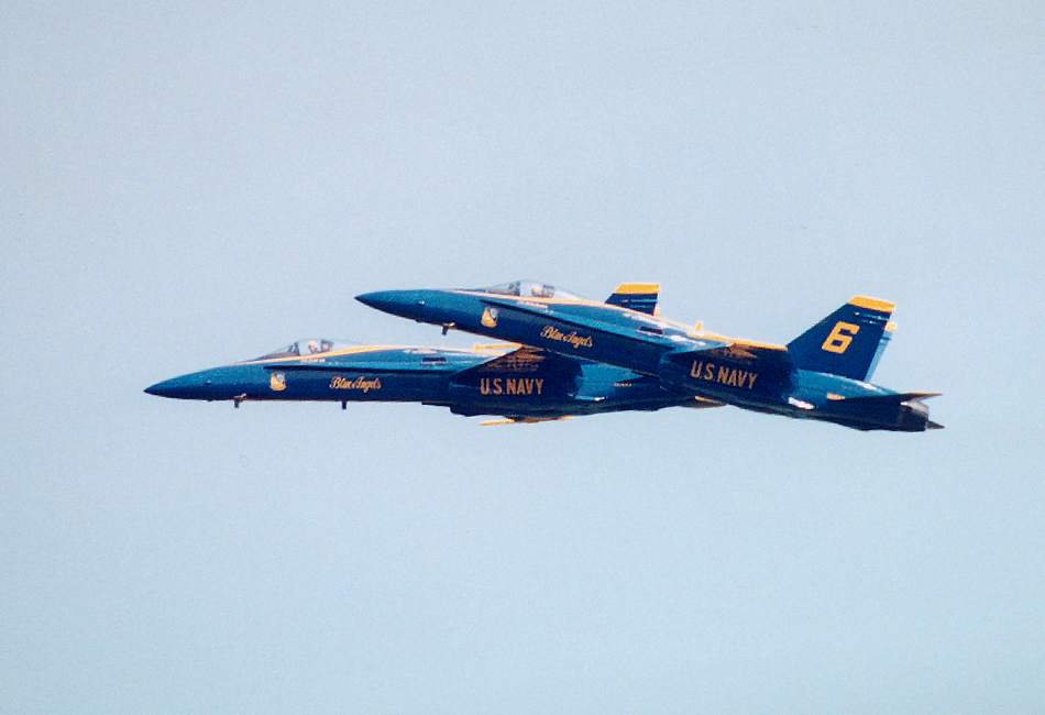 two Blue Angels side by side, one pulling up