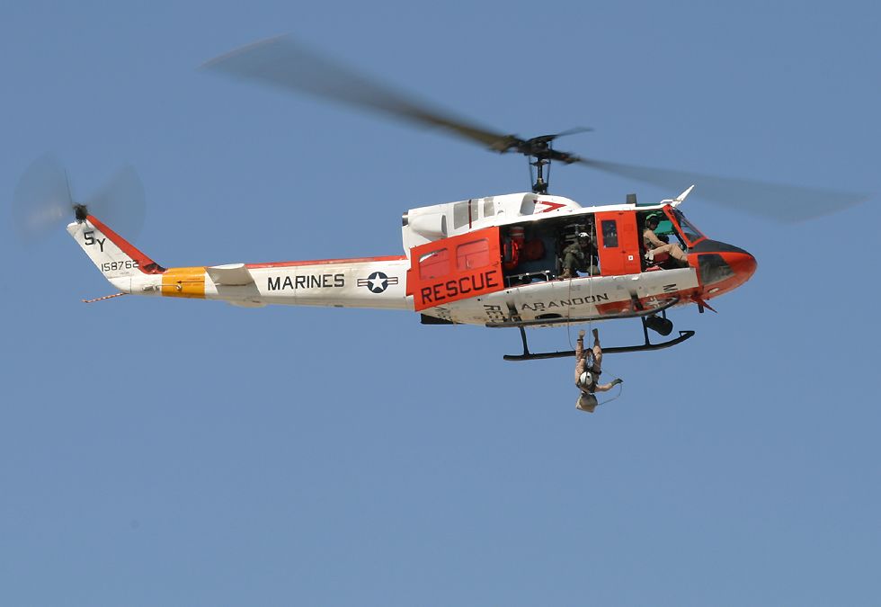 crewman exiting UH-1 search and rescue helicopter
