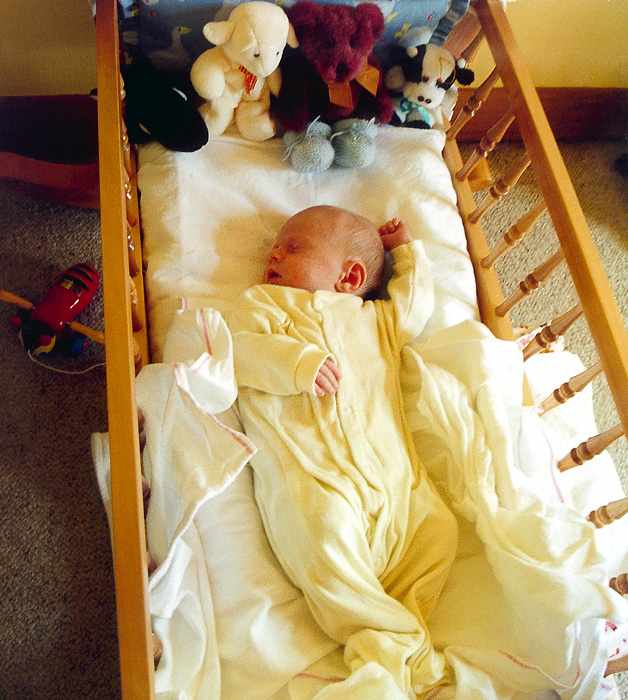 Charles in a cot made by dad