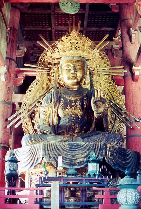 large gilded female figure alongside the Great Buddha