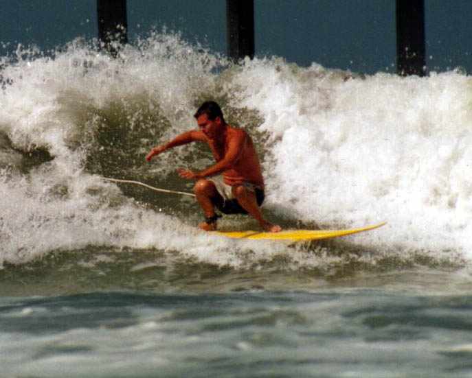 surfer crouching on board at end of ride