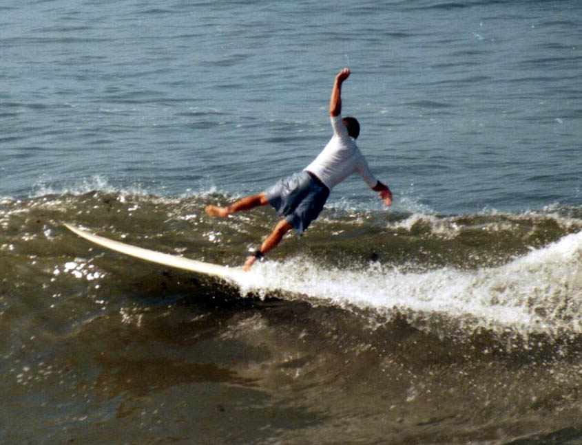 surfer bailing off his board on an ordinary looking wave