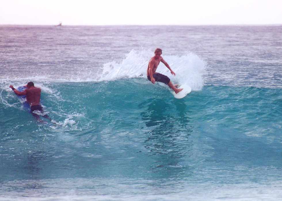 surfer steers around a boogie boarder