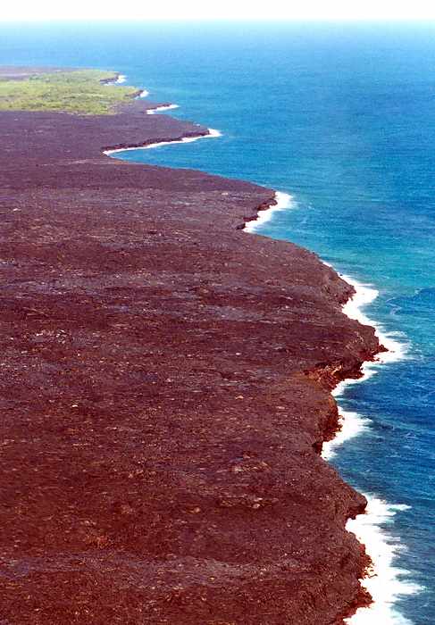 wide angle view of the lava field as it forms new coastline