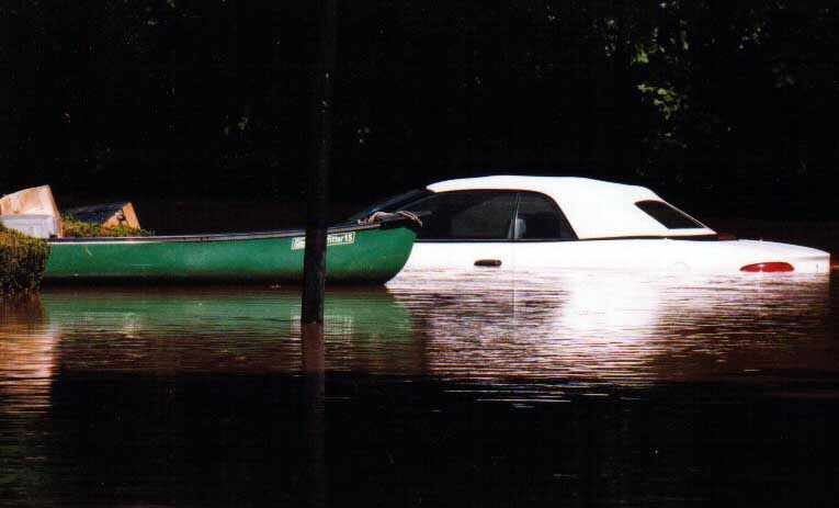 flooded car next to canoe