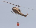 army Huey with monsoon bucket with guy hanging out door